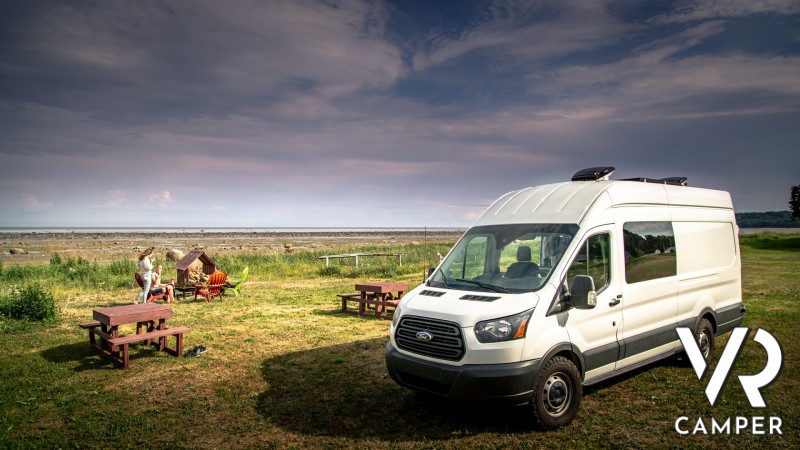 White Van parked near a pic-nic area